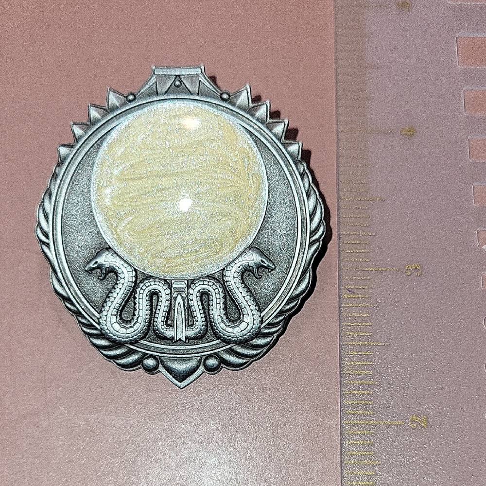 Intricate Silver and Cream Medallion with Snake Motif